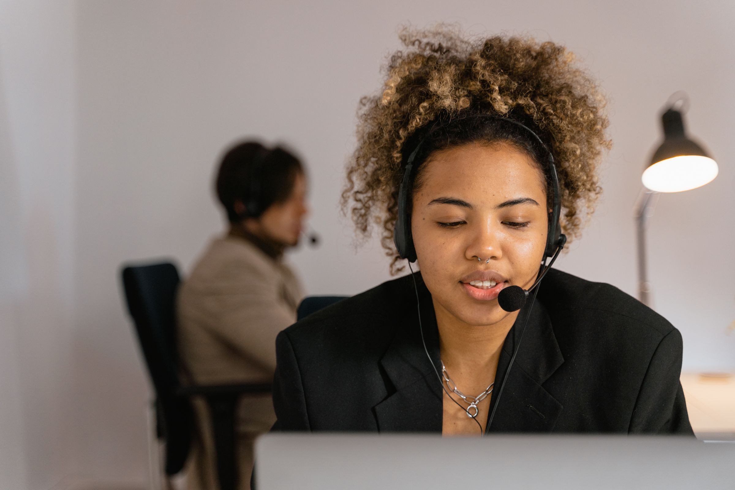 A support agent with a headset at her desk