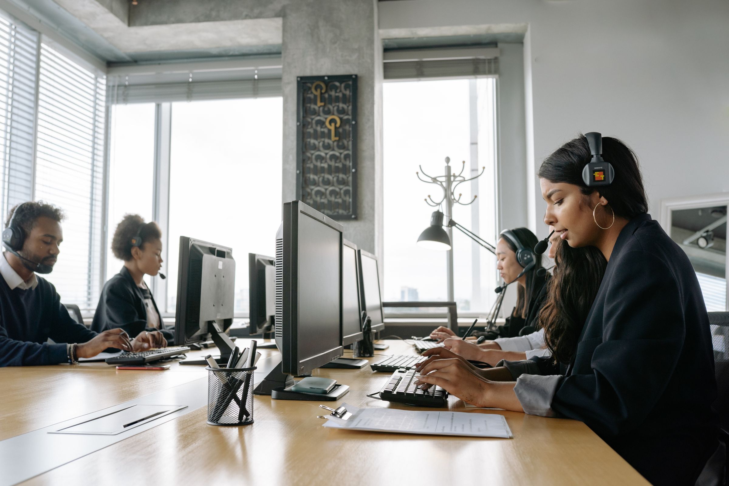 A support team with headsets working at their desks